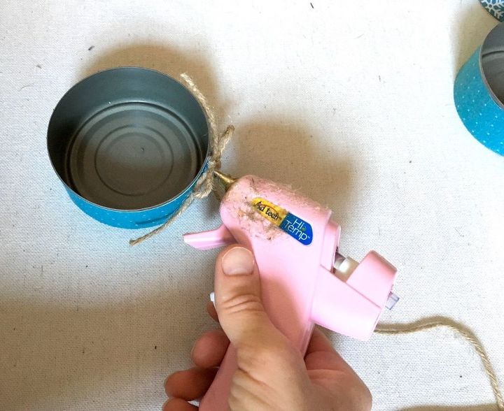 s transform tuna cans into gorgeous lighting in 9 simple steps, Step 8 Hot glue bows twine strings to cans