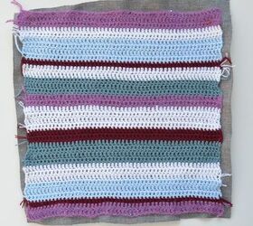 transform garden furniture with a bright striped crochet cushion