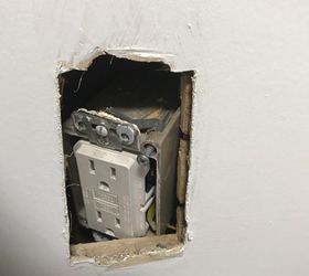 my kitchen outlet pushed back into the wall how do i fix it