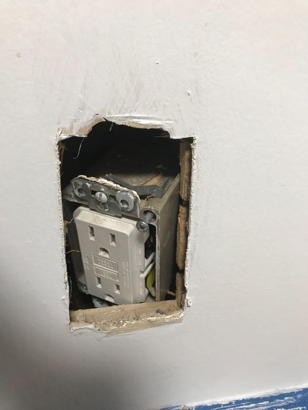 my kitchen outlet pushed back into the wall how do i fix it