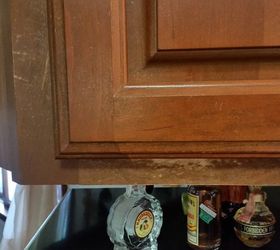 How can I fix the peeling lacquer clear coat on my kitchen cabinets?