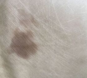 q how to clean a spot on leather couch not sure what it is