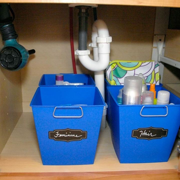 30 space saving storage ideas that ll keep your home organized, Organize your under the sink with bins