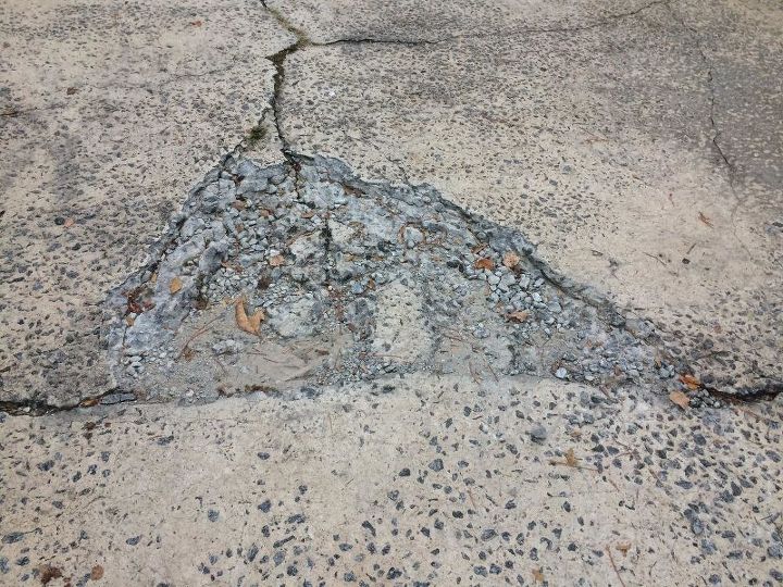 q repairing broken concrete patch on driveway