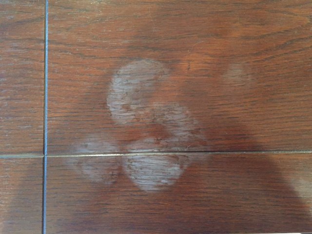 q how can i remove white heat water marks from my dining room table