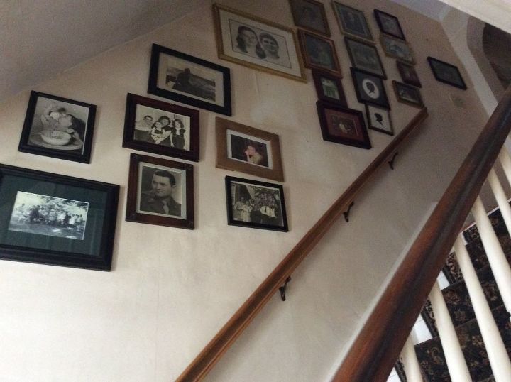 need to re hang pictures on a staircase wall nail holes enlarged