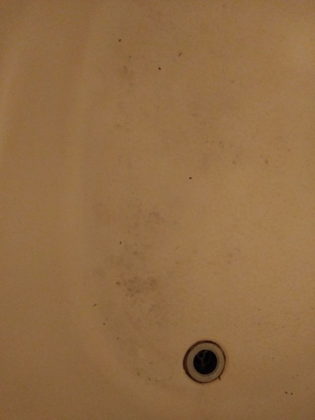 dirty and discolored looking fiberglass tub
