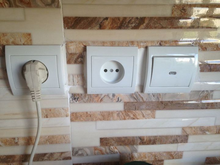q covering cracks around electric switch
