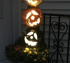 s 10 spook tacular ways to dress up your dollar store pumpkins, Make them glow on your porch