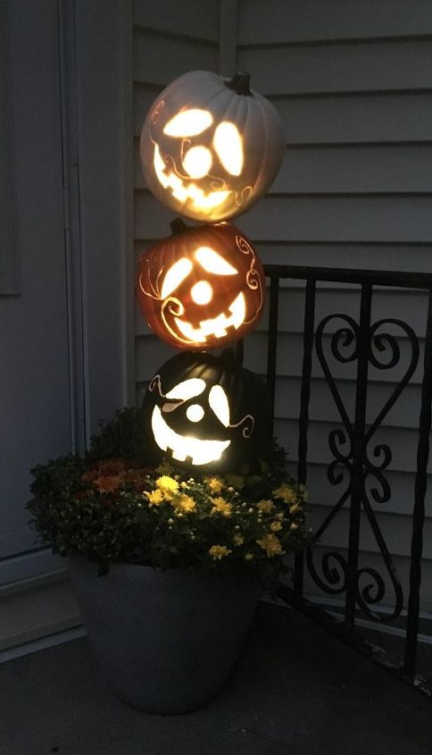 s 10 spook tacular ways to dress up your dollar store pumpkins, Make them glow on your porch