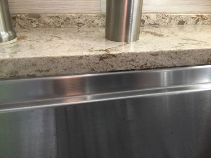 how to clean caulking turned black between ss sink and quartz counter