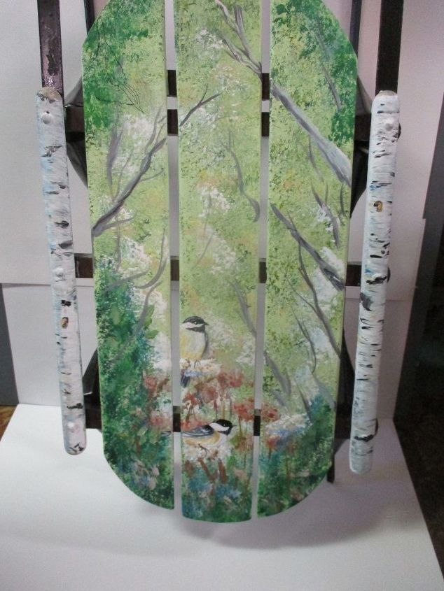 a painted sled for christmas with chickadees and nuthatch