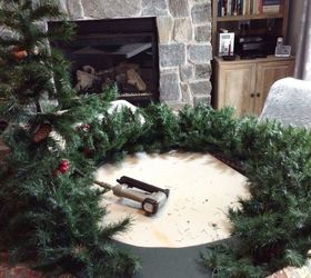 una corona de navidad gigante, Engrapando las ramas del rbol a la madera contrachapada