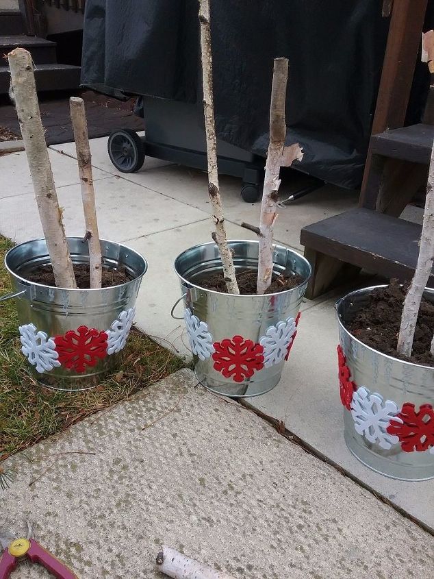 galvanized metal pails turned outdoor winter planters