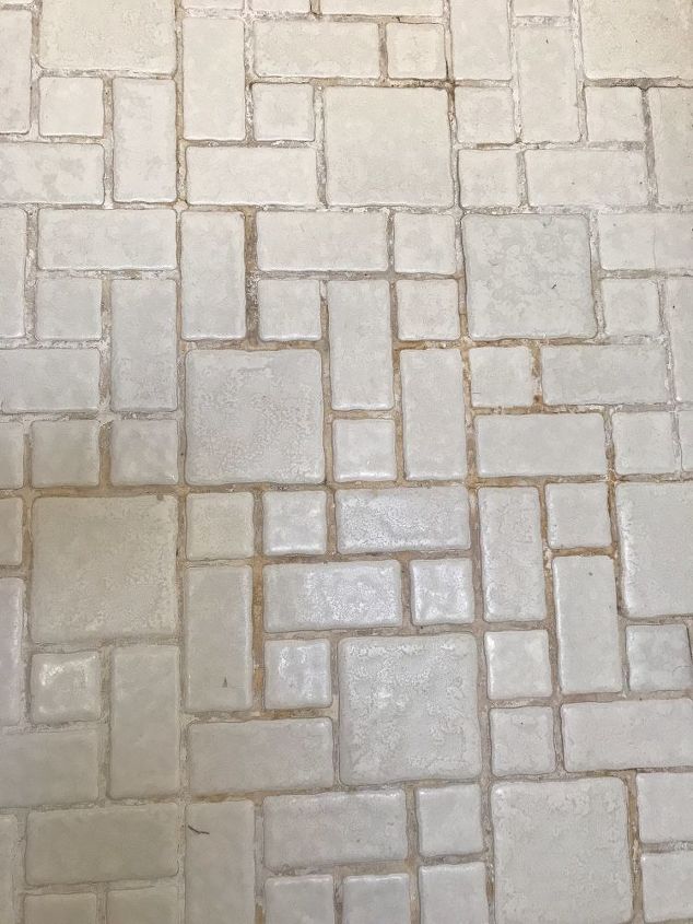 Ugly grout stains and old white mosaic like bathroom floor