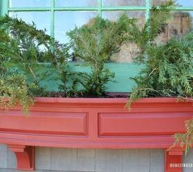 sprucing up window boxes with christmas greenery