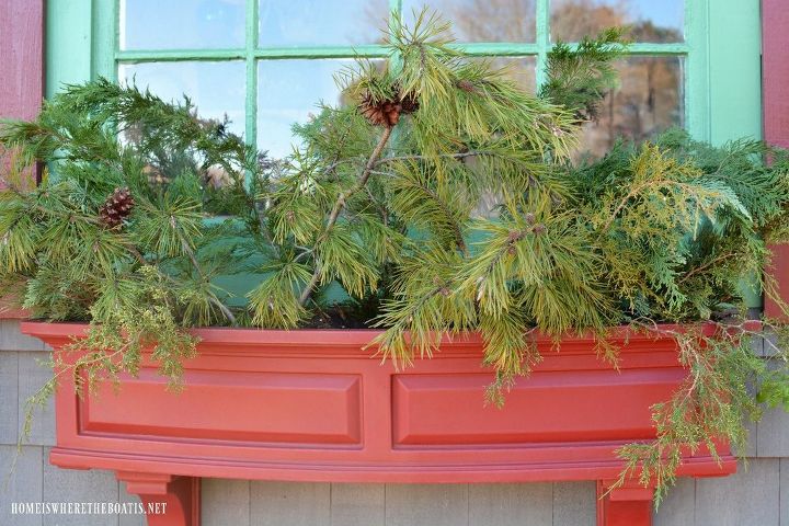 sprucing up window boxes with christmas greenery