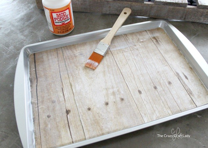s 3 great projects to flip your cookie sheet pans, Step 1 Apply Mod Podge on craft paper