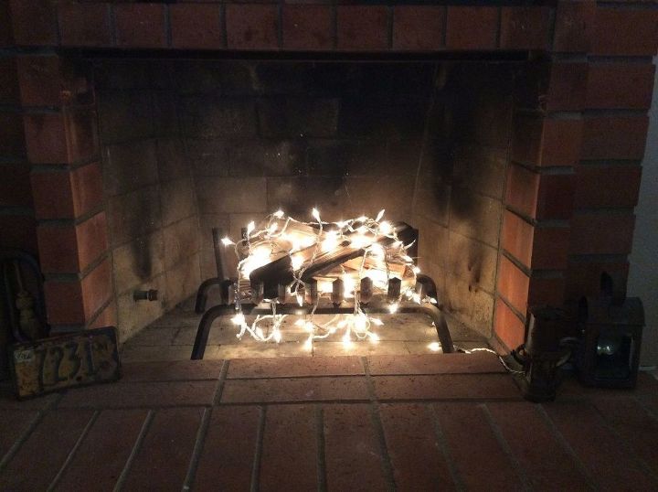 15 unexpected ways use christmas lights in your home, Fake a cozy fireplace