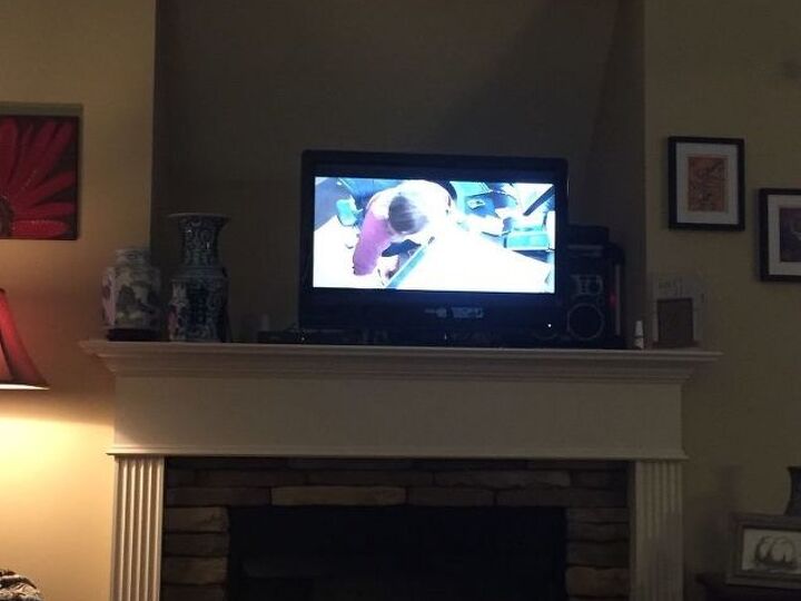 q how can i decorate a huge recessed tv opening over my mantle