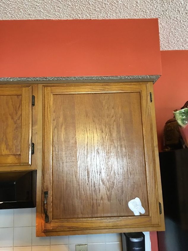 q what can i do about this ugly soffit above my cabinets to update it