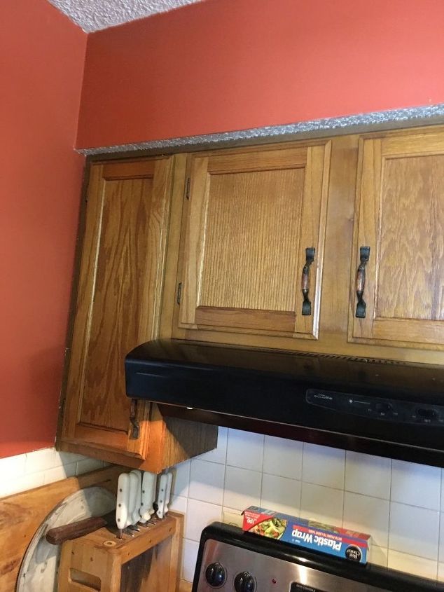 q what can i do about this ugly soffit above my cabinets to update it