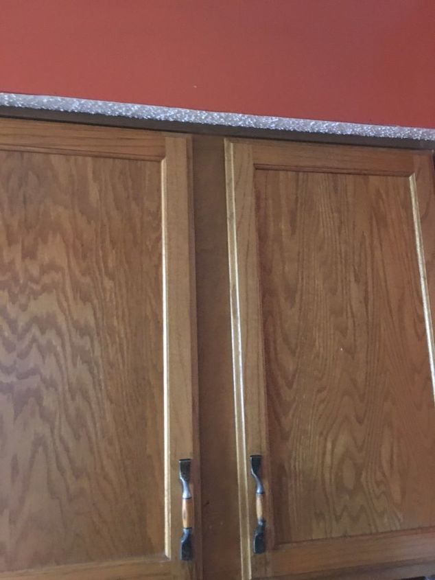 q what can i do about this ugly soffit above my cabinets to update it