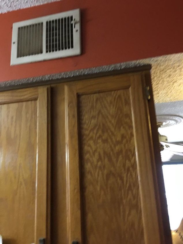 q what can i do about this ugly soffit above my cabinets to update it