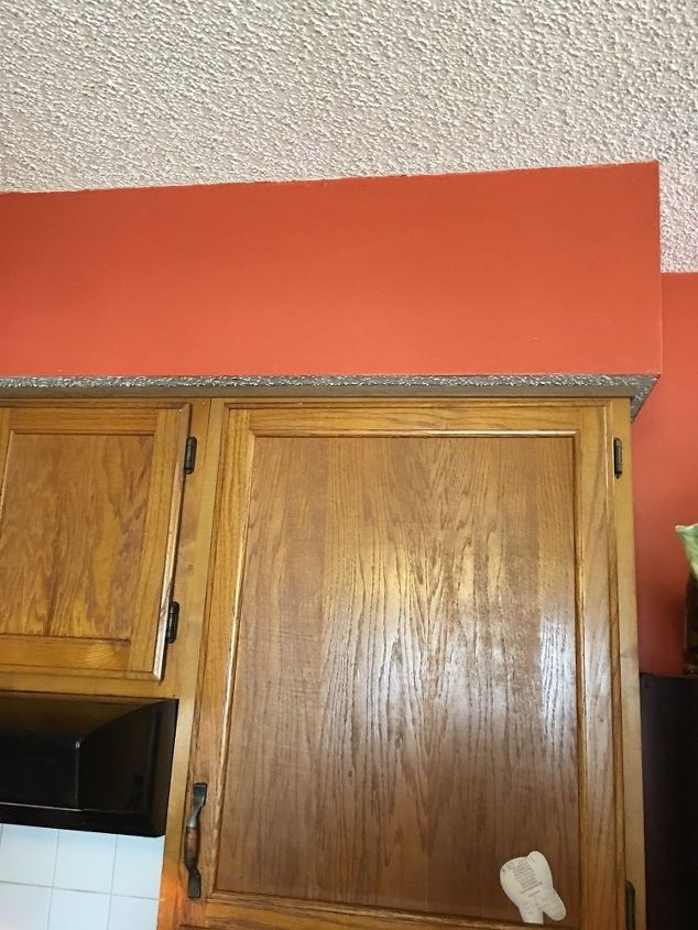 q what can i do about this ugly soffit above my cabinets to update it