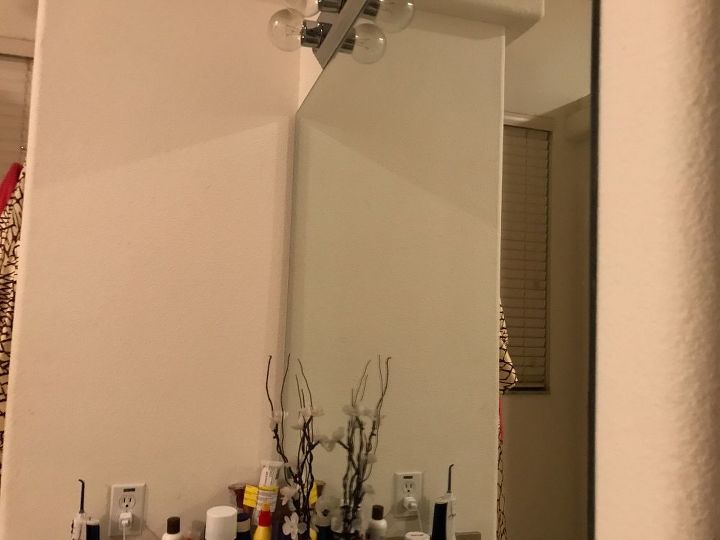 q taking down a large bathroom mirror