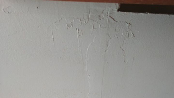 bathroom wall there are cracks and slight dents