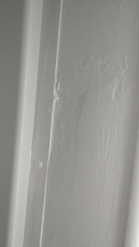 bathroom wall there are cracks and slight dents