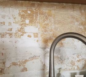Is there a way to remove old tile glue from walls ?