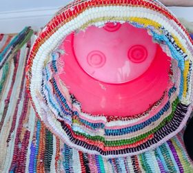 Mom uses a plastic bucket & a rug for this brilliant storage idea