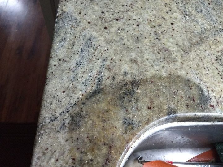 have a dark gray spot on my granite countertops how do i refinish the