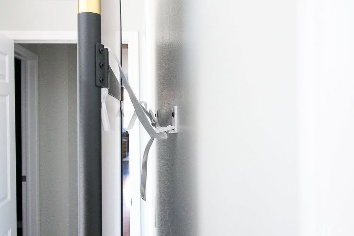 how to secure a standing mirror to the wall