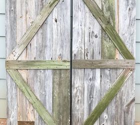 one of a kind sliding barn door with a pet door built in it