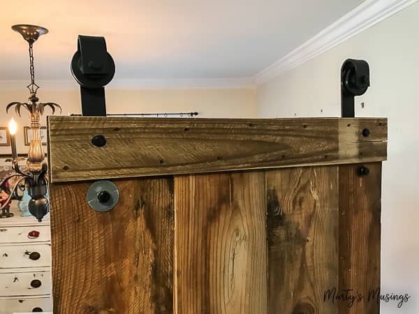 one of a kind sliding barn door with a pet door built in it