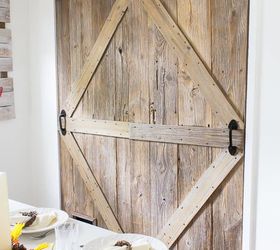 one of a kind sliding barn door with a pet door built in it