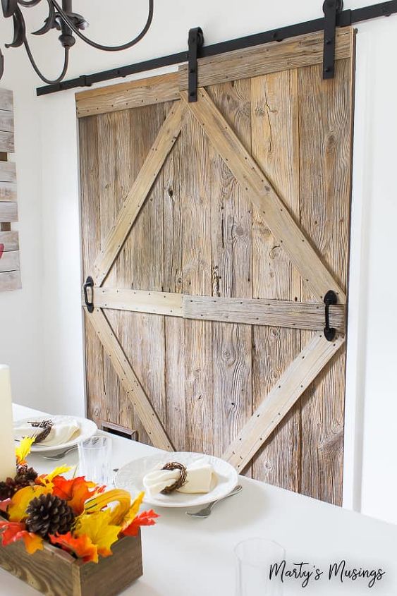 one of a kind sliding barn door with a pet door built in it