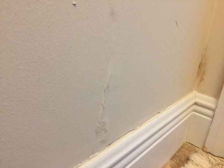 q how to fixed water damage raised section of wall
