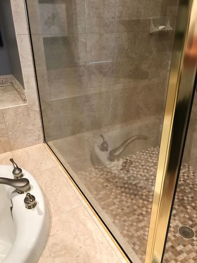 q what is the best way to remove water deposits from a glass shower