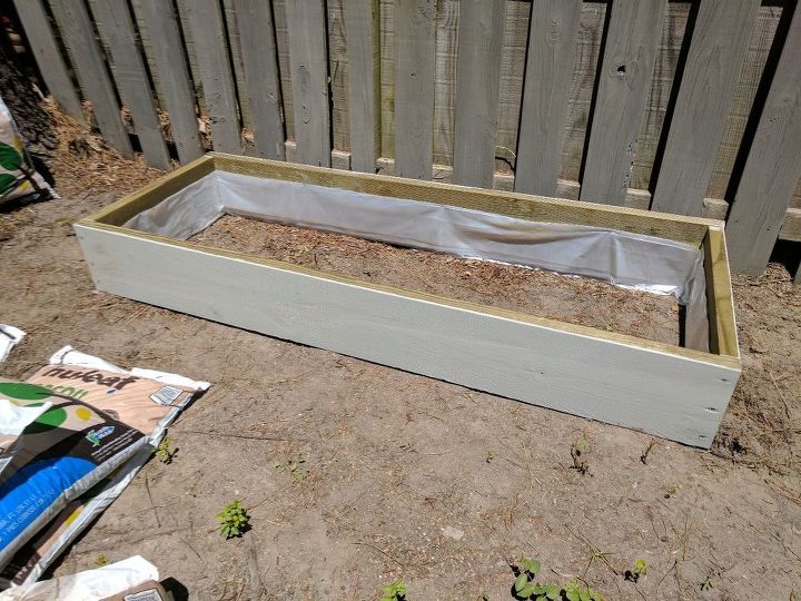 build two raised herb gardens for less than 50, Staple plastic to inner sides of boards