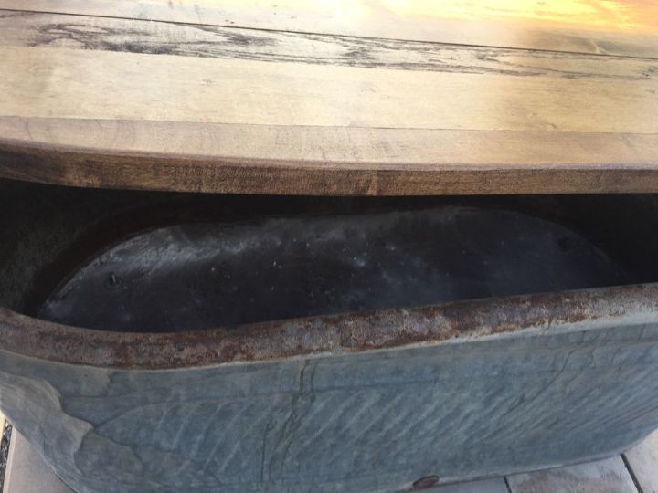 old water trough to a patio storage and table