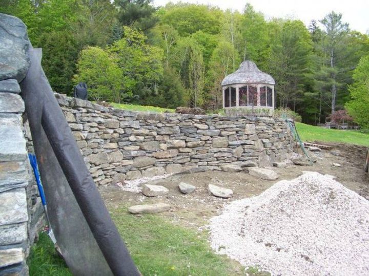 s how to get backyard privacy without a fence, Stack tons of rocks together