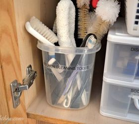 s the 15 smartest storage hacks for under your sink, Store scrub brushes in a large plastic bucket