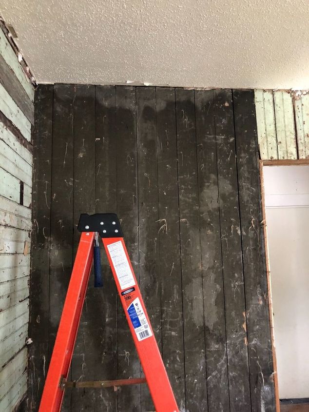 q painting roller brush or sprayer on shiplap