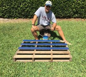 He paints a row of pallets with blue paint for this great outdoor update