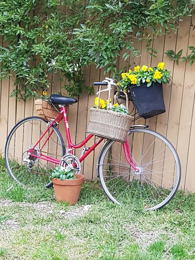 red bicycle planted up as garden art