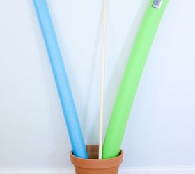 Put 2 pool noodles in a flower pot for this amazing decor idea